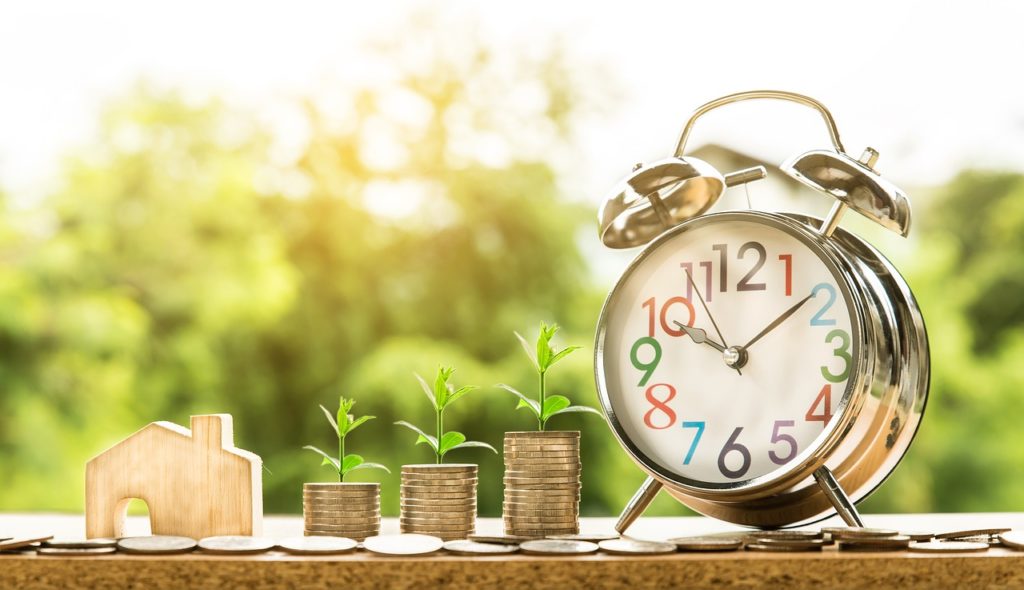 stack of coins and a clock