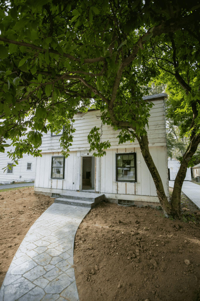 House with a tree in the front.