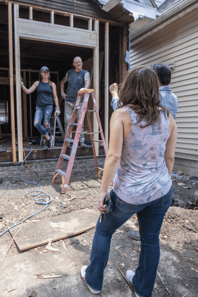 A group of people talking in a construction area.