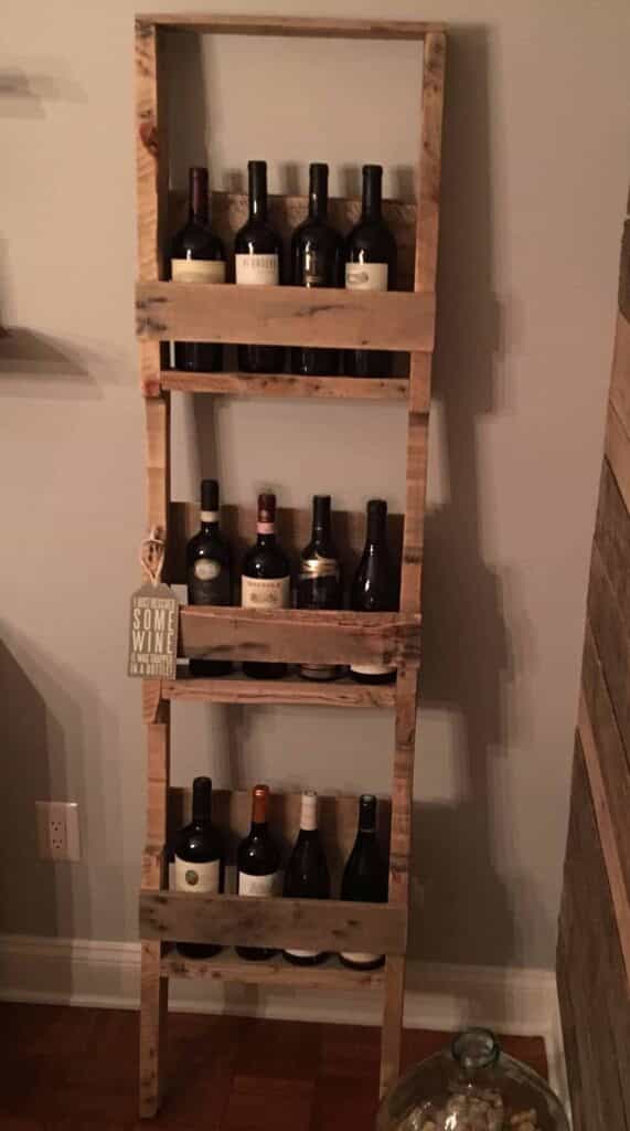 Tall, slender wooden wine rack in the form of a leaning ladder.