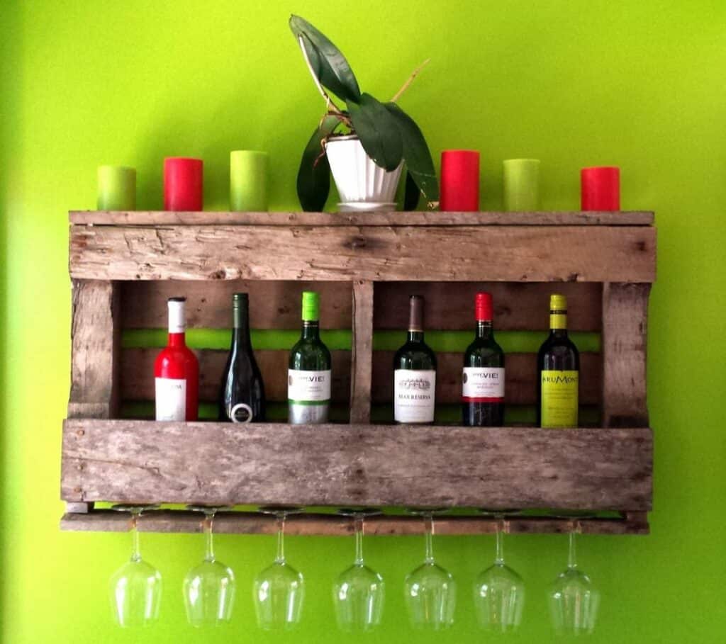 Small wall wine rack with colorful candles on top. 