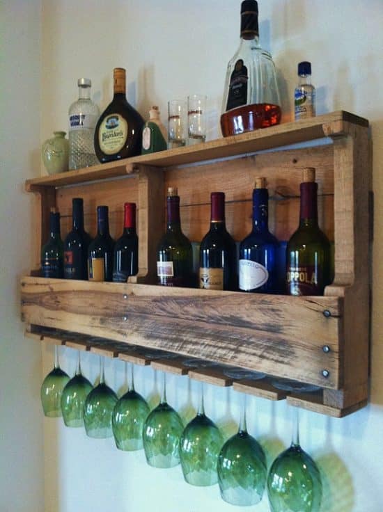 Wall wine rack with holes for holding glasses.